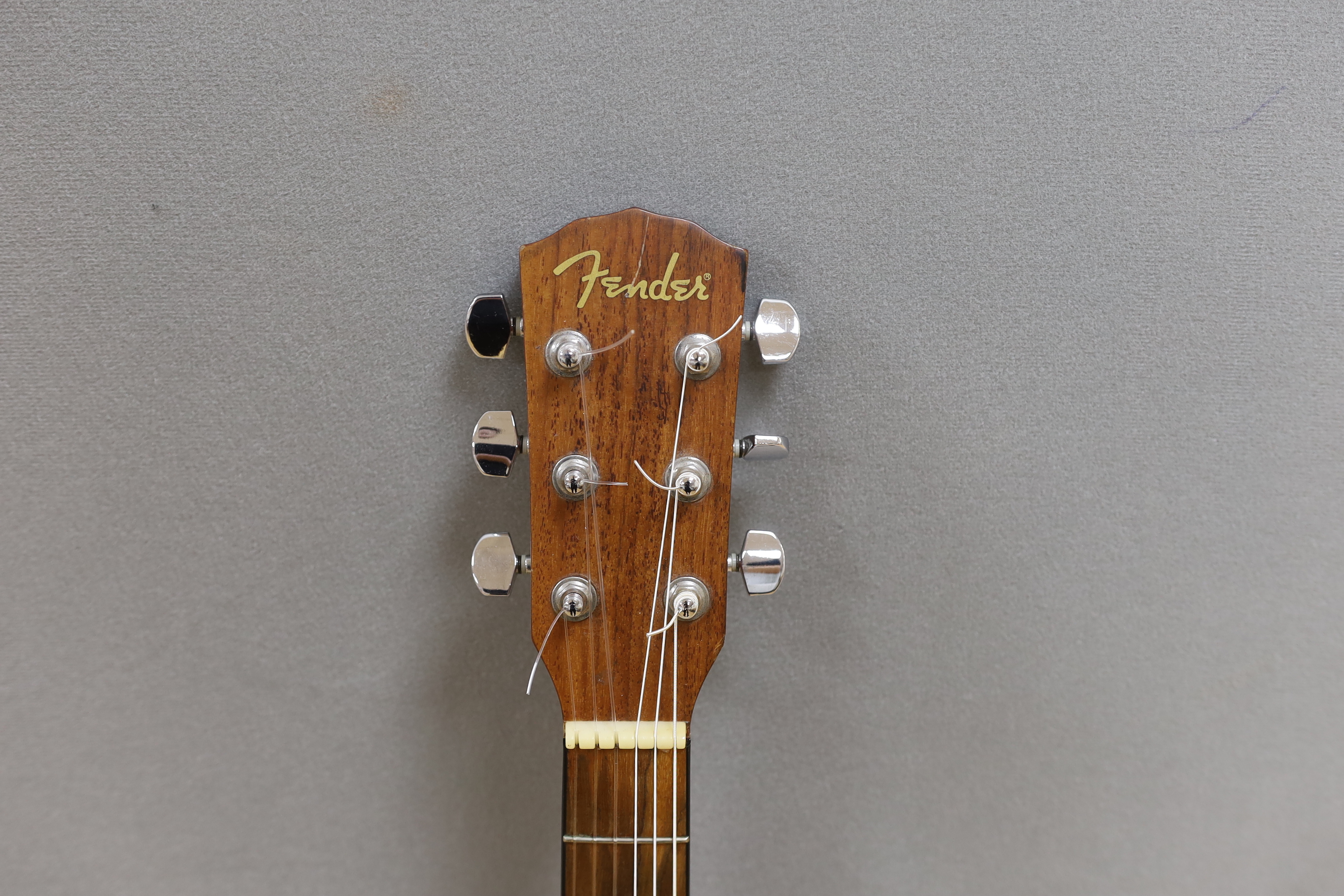 A Fender acoustic left handed guitar, in case